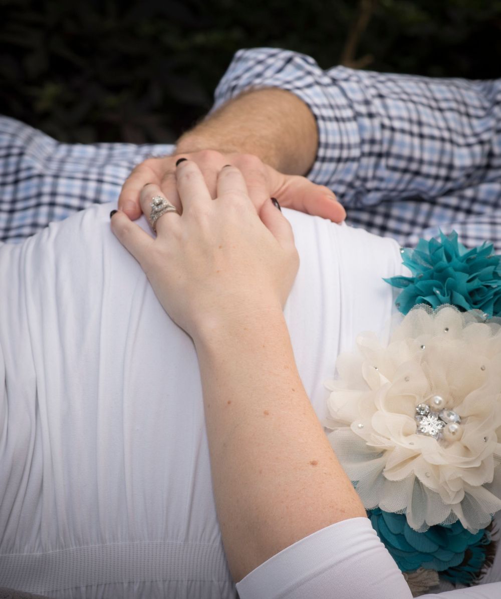waiting to our little one. Expecting couple embracing during maternity photography session in Houston, Texas