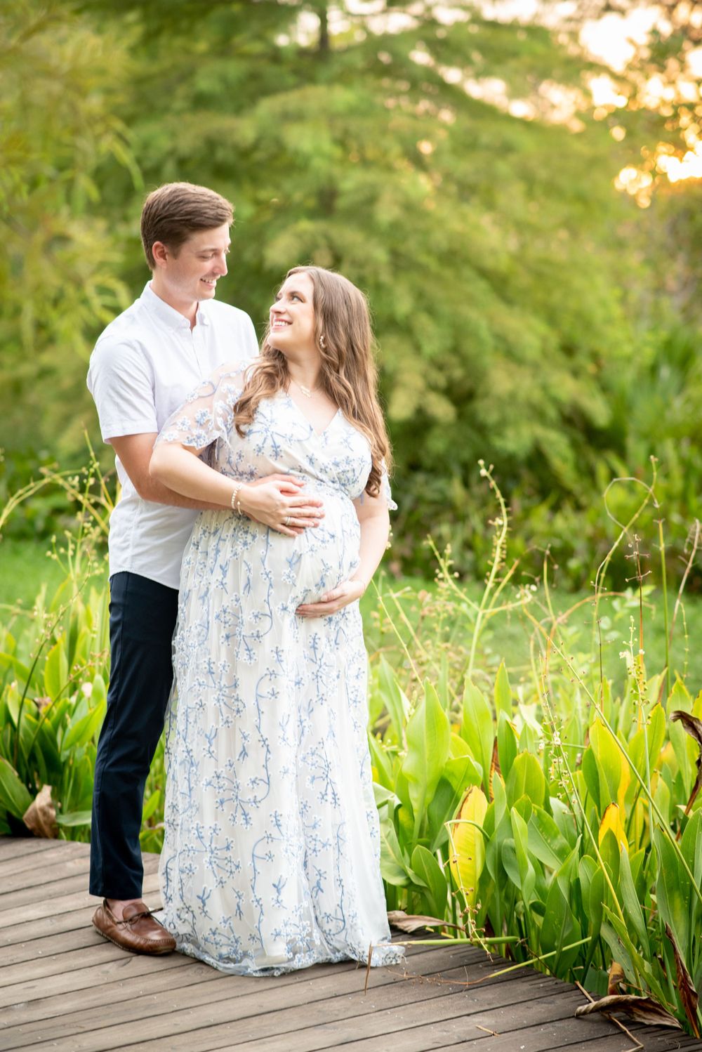 a lush landscape maternity photography session at the Houston arboretum with expecting mother and father.