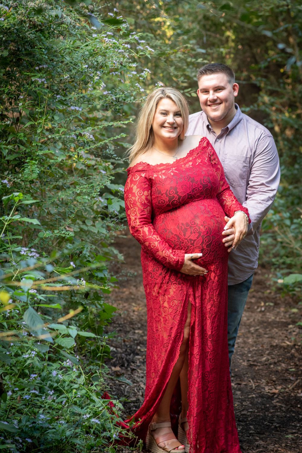 just glowing. Glowing mother-to-be surrounded by trees during boutique outdoor maternity photography session at the Houston Arboretum