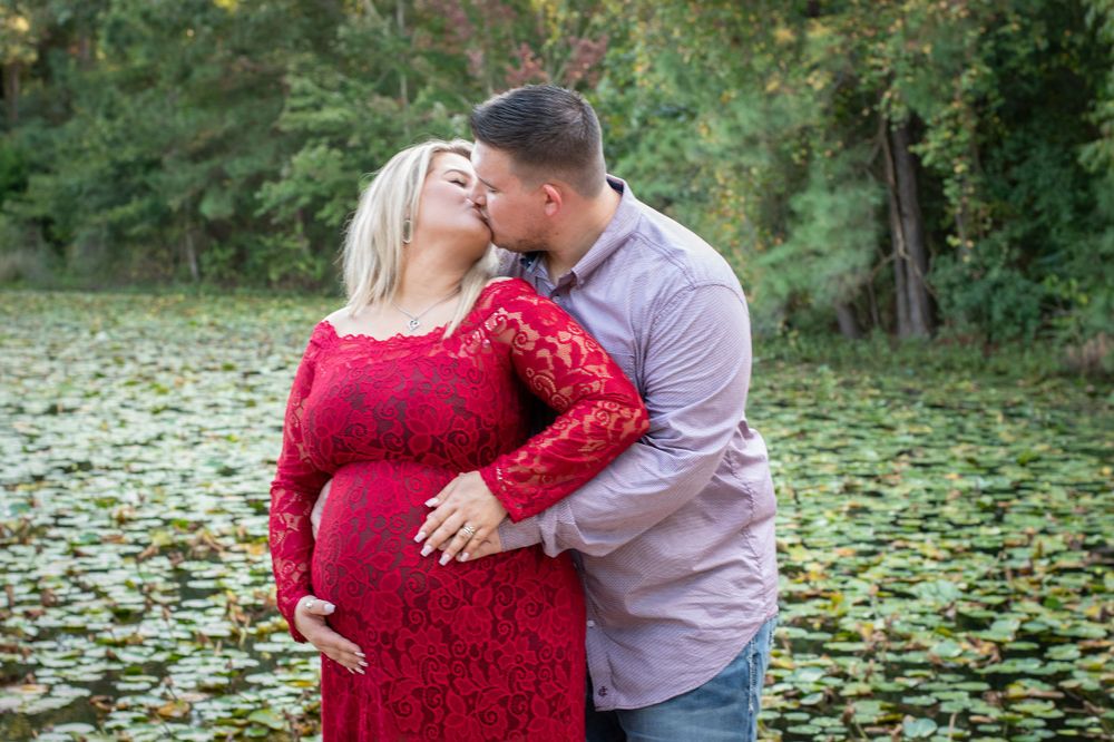 love. Glowing mother-to-be and father-to-be surrounded by Lilly during outdoor maternity photography session at the Houston Arboretum in
