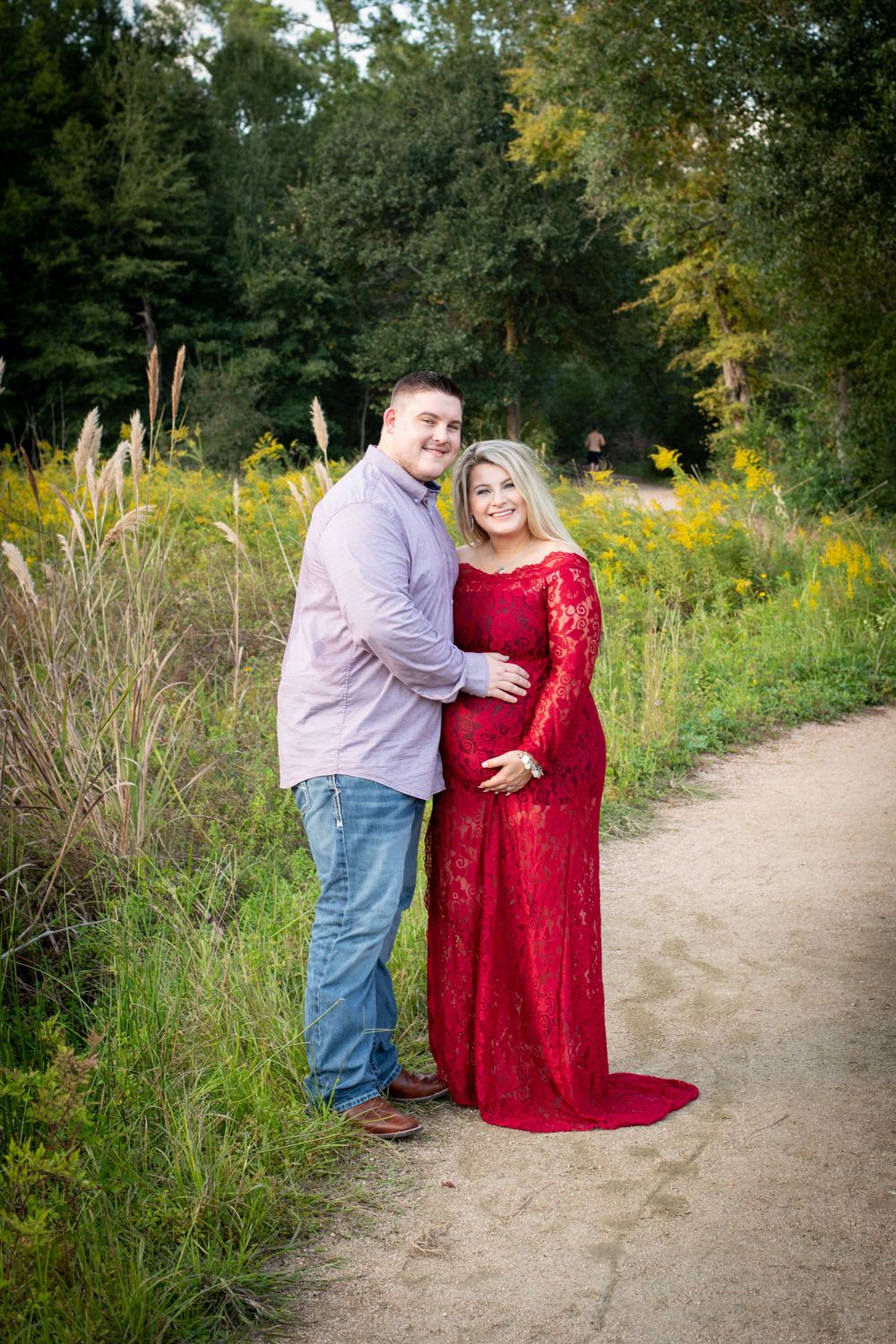 Waiting for baby. Glowing mother-to-be surrounded by trees during outdoor maternity photography session at the Houston Arboretum