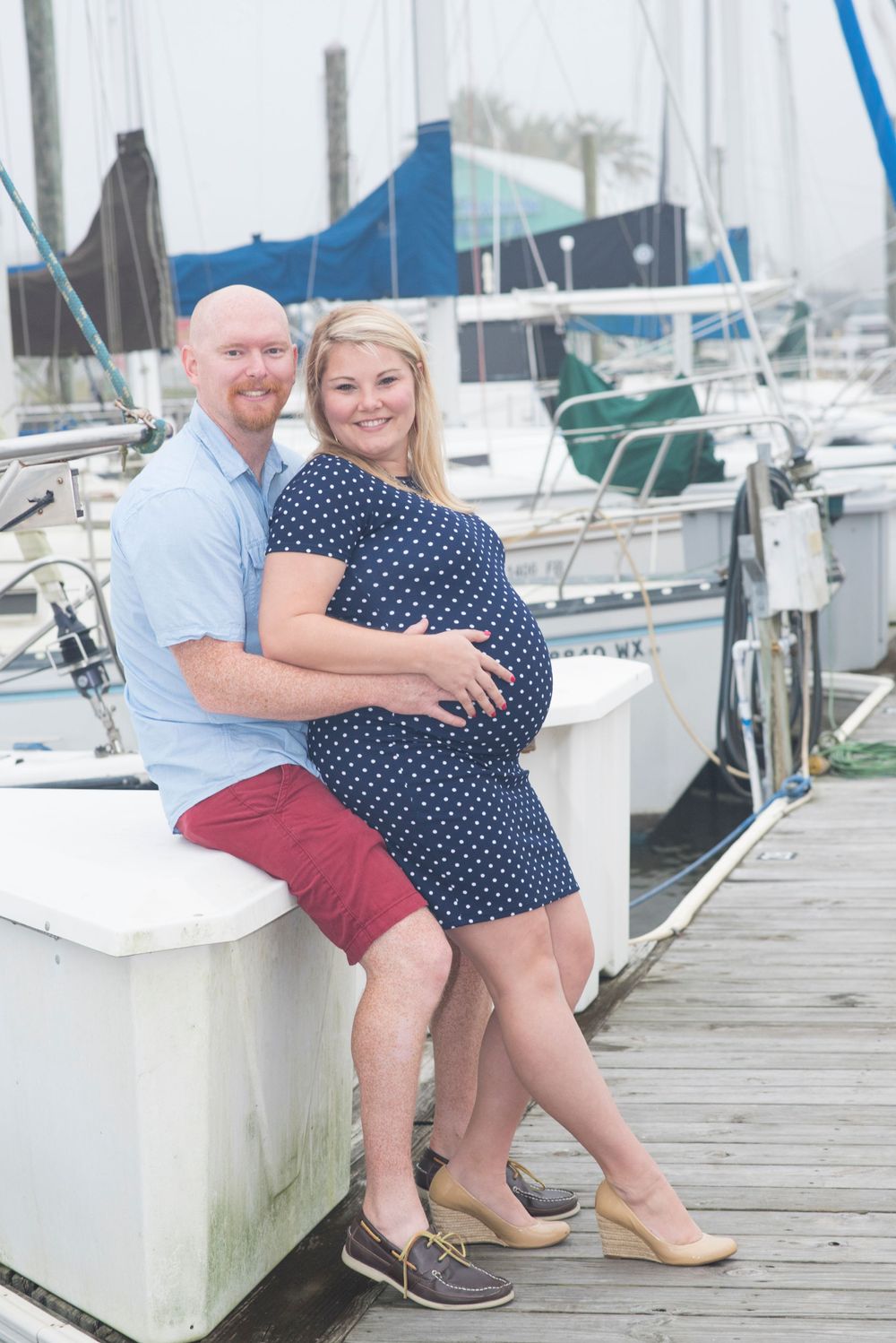 boating and baby. Expecting mother, father, and little sister, during Houston maternity photography session at boat dock in Houston