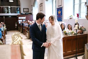 Traditional church wedding ceremony with ornate architecture and stained glass windows.