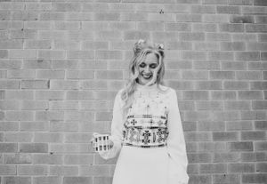 A black and white portrait against a brick wall showing pure joy.