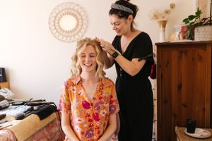 Getting ready for a special occasion with hair styling preparations in a cozy room.