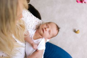 A sleeping infant in white clothing rests peacefully.