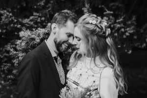 A tender black and white moment captured between a couple during their wedding.