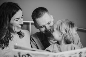 Intimate black and white portrait of family sharing joyful moment together.