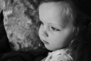 Close-up black and white portrait showing gentle expression and delicate features.