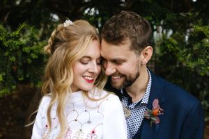 An intimate outdoor portrait showcasing a romantic moment amidst greenery.