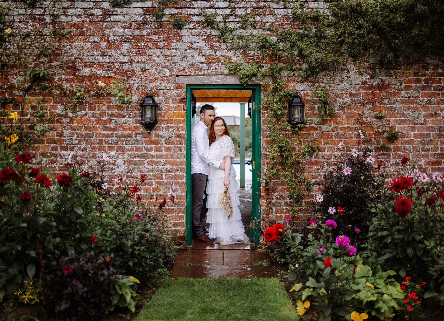 couple sheltering from rain Cumbria wedding photographer