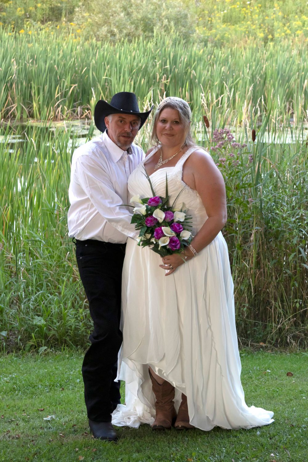 Groom hugging his bride in an outdoor setting