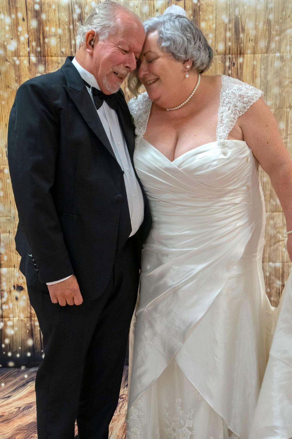 Bride and groom with foreheads together smiling