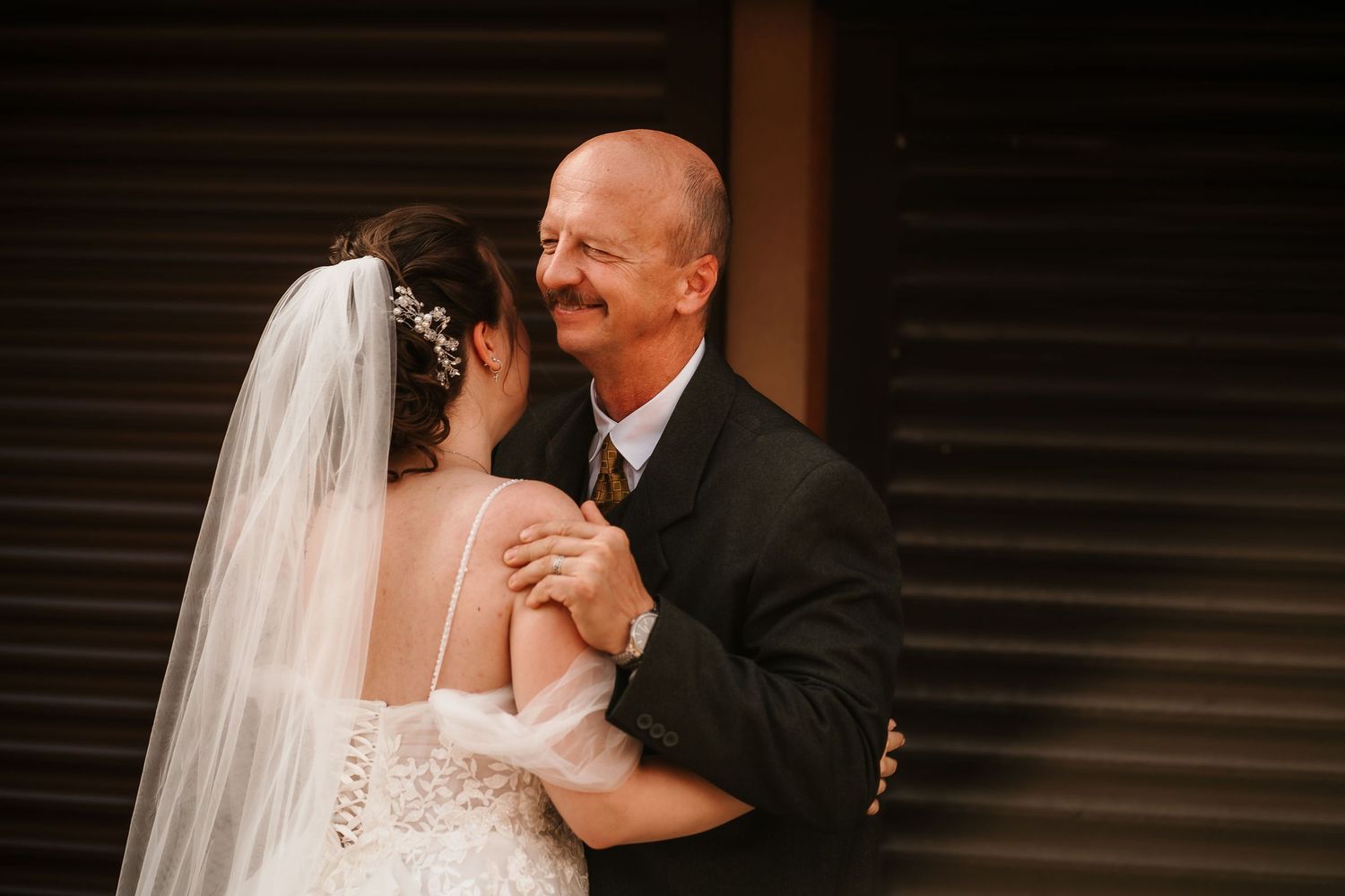 A romantic embrace between newlyweds during their wedding ceremony.