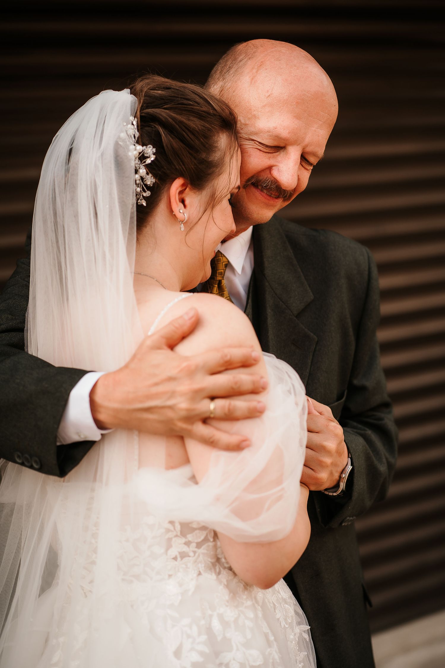 A candid moment of joy shared between newlyweds during their wedding day.