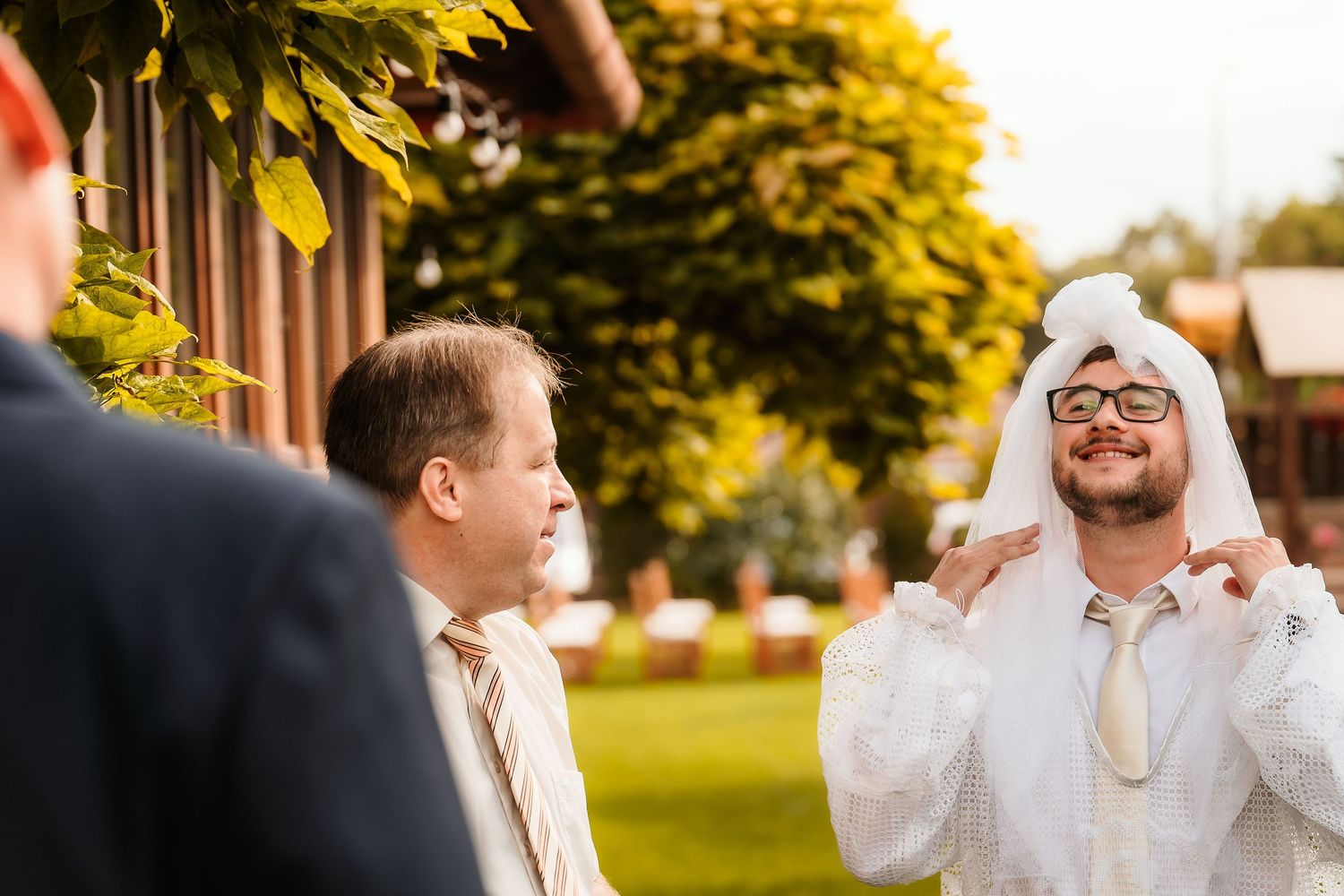 Wedding celebration participants sharing a lighthearted moment outdoors.