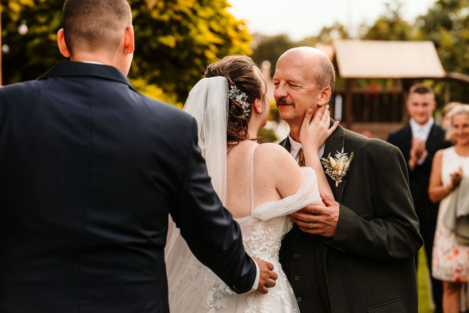 A heartfelt moment during a wedding ceremony as participants share an emotional exchange.