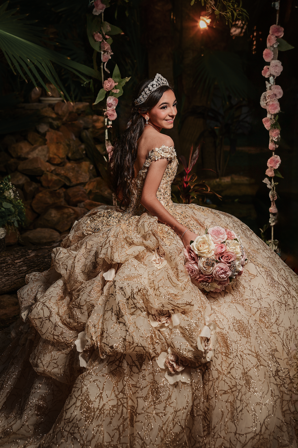 Romantic evening portrait in a champagne ballgown with floral bouquet and sparkly tiara.