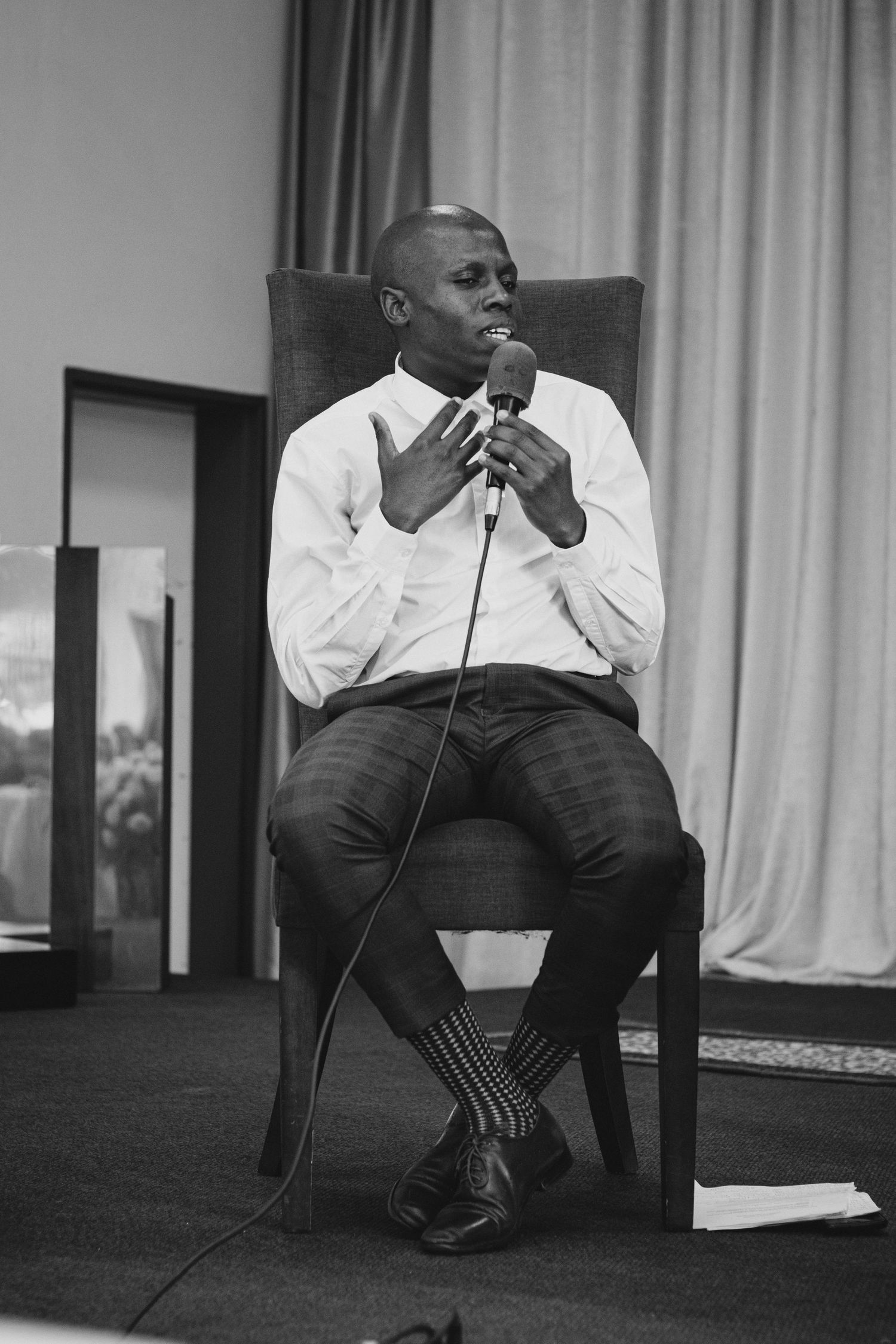 Corporate events photography, man sitting and having a panel discussion.