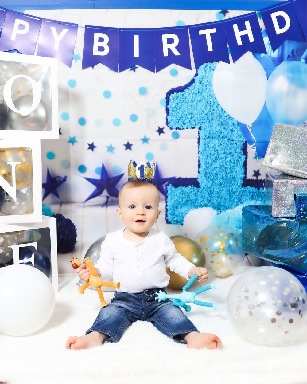First birthday party setup with blue banner, stars and number one decoration.