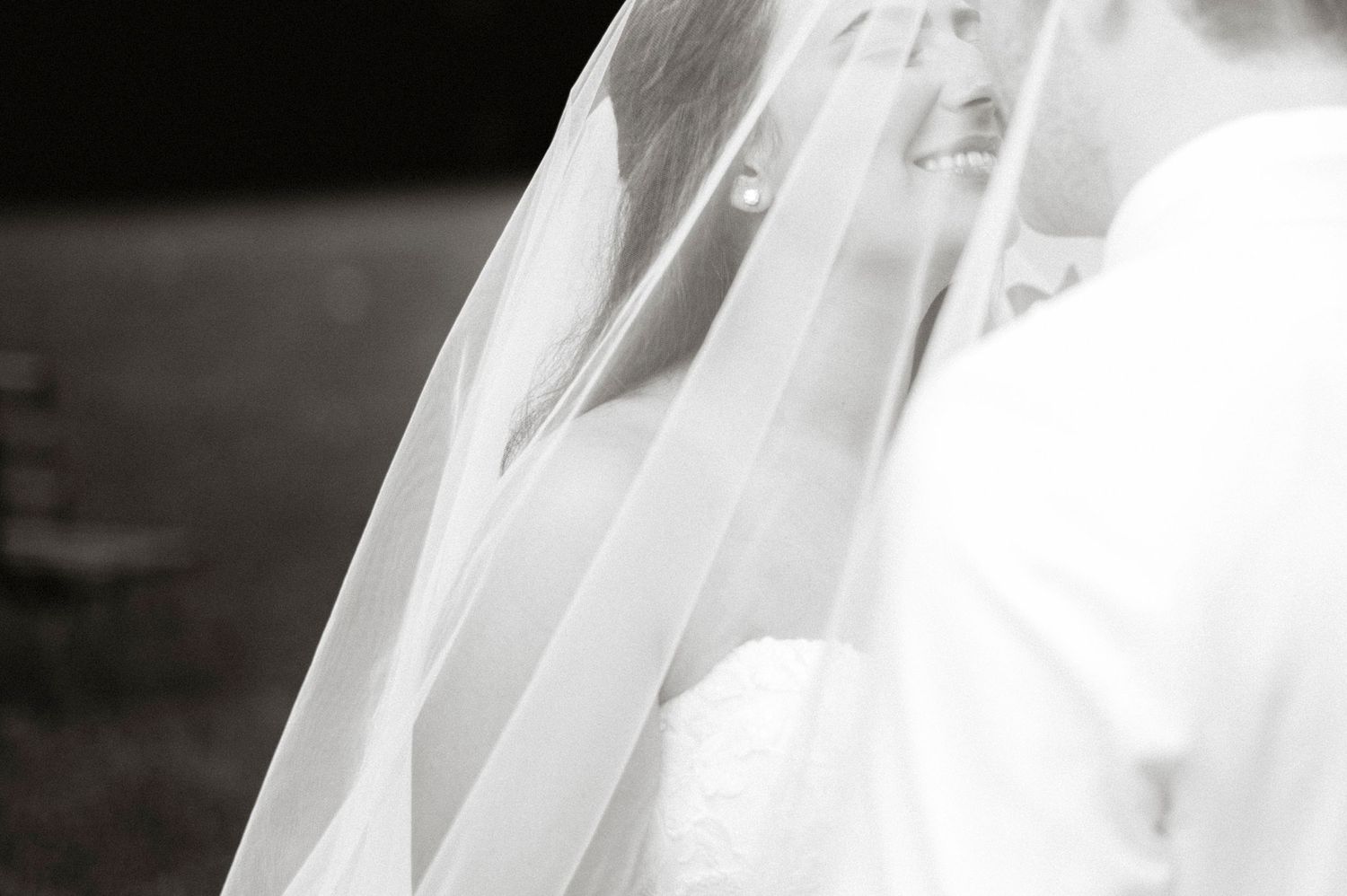 Artistic black and white detail shot of a delicate bridal veil.