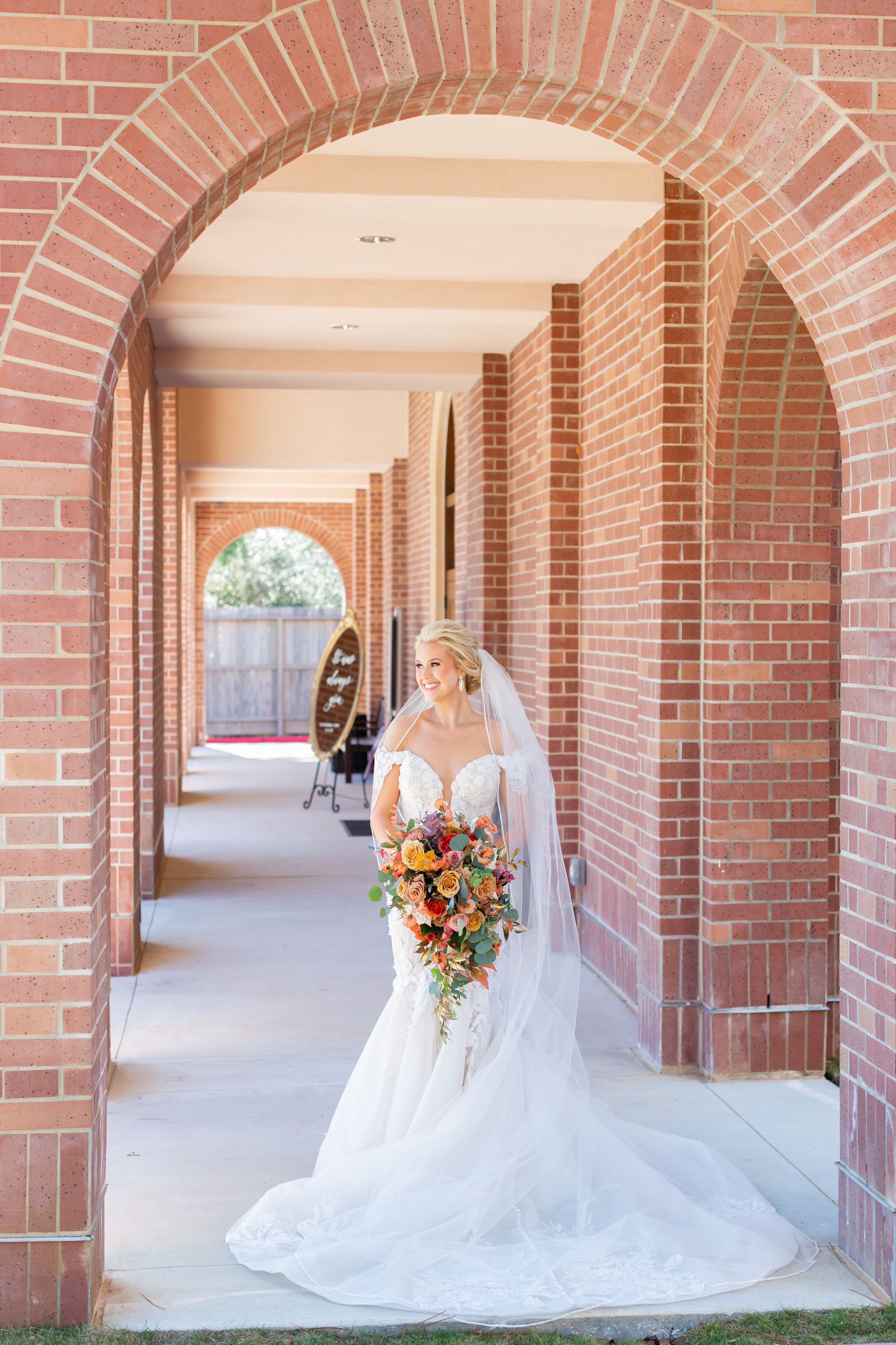 Bride poses with her bouquet outside of a church in Houston, TX.
