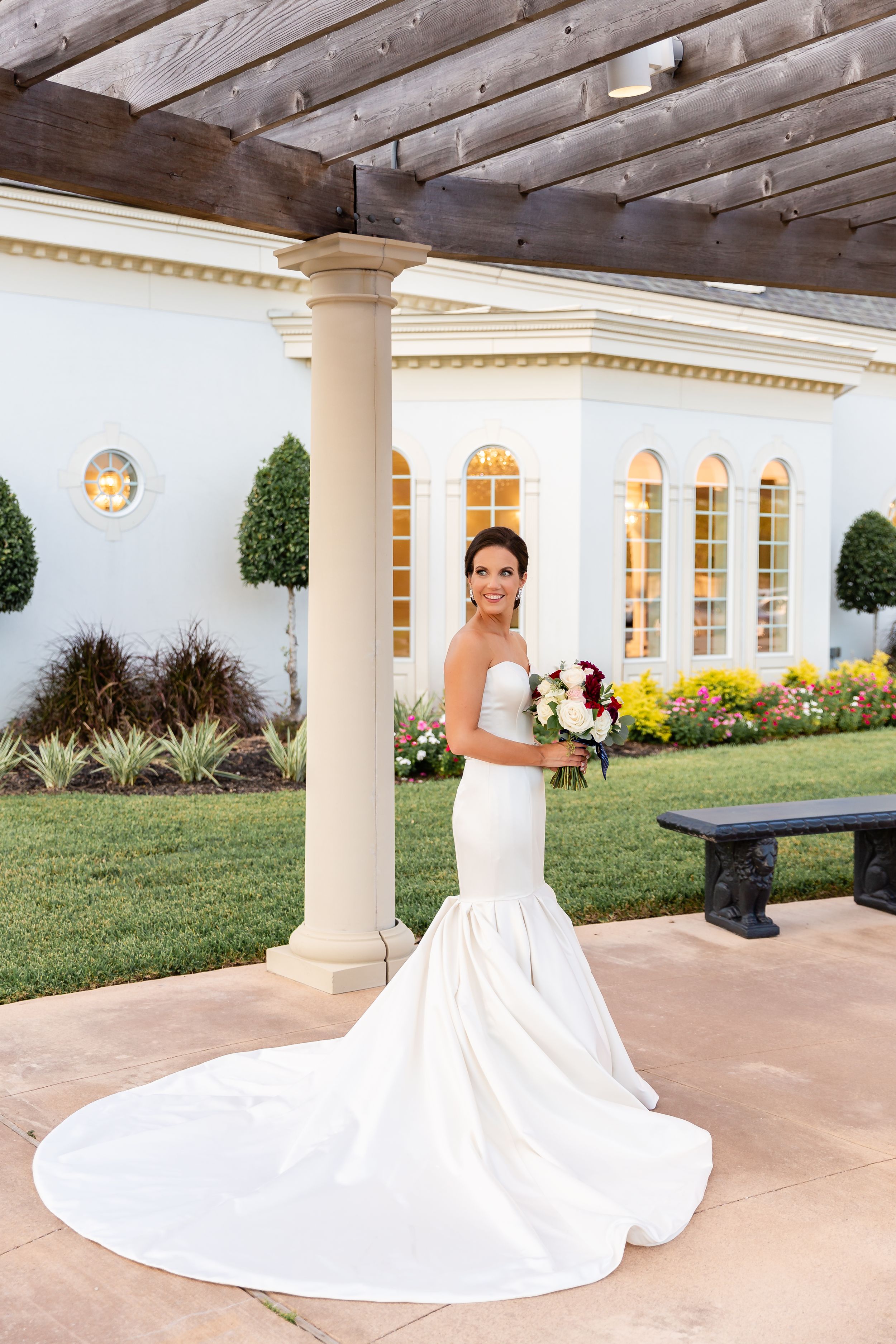 Bride poses outside near the garden at Ashton Gardens West in Houston, TX.