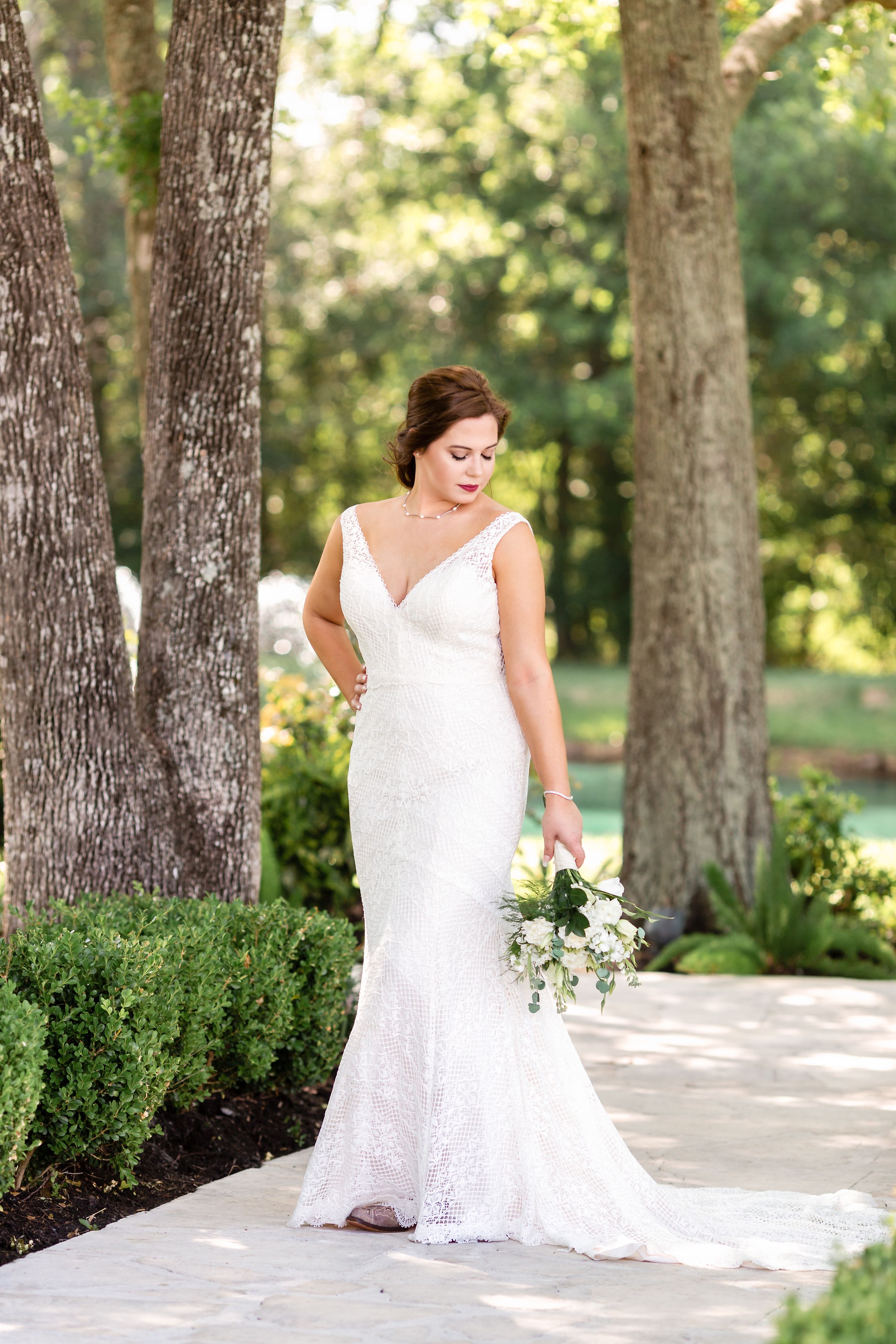 Megan looks down and over her shoulder during her bridal session in Houston, TX.