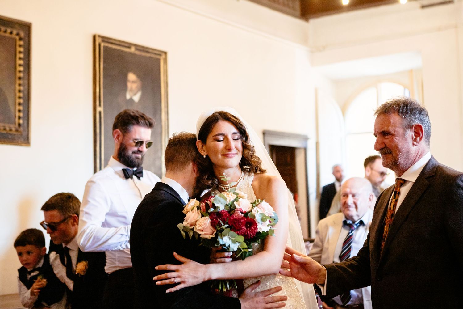 A bride hugs her groom having walked down the aisle for her Italy civil wedding ceremony.