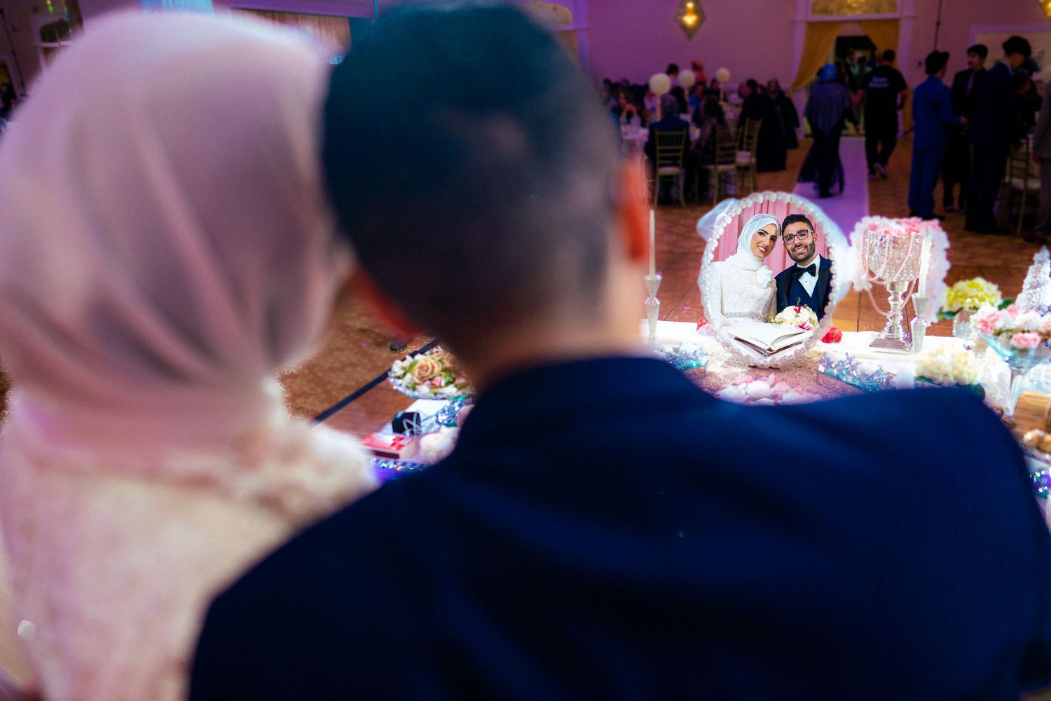 Arab couple gazes at each other in a mirror, the camera captures their bond, evoking shared moments and timeless love