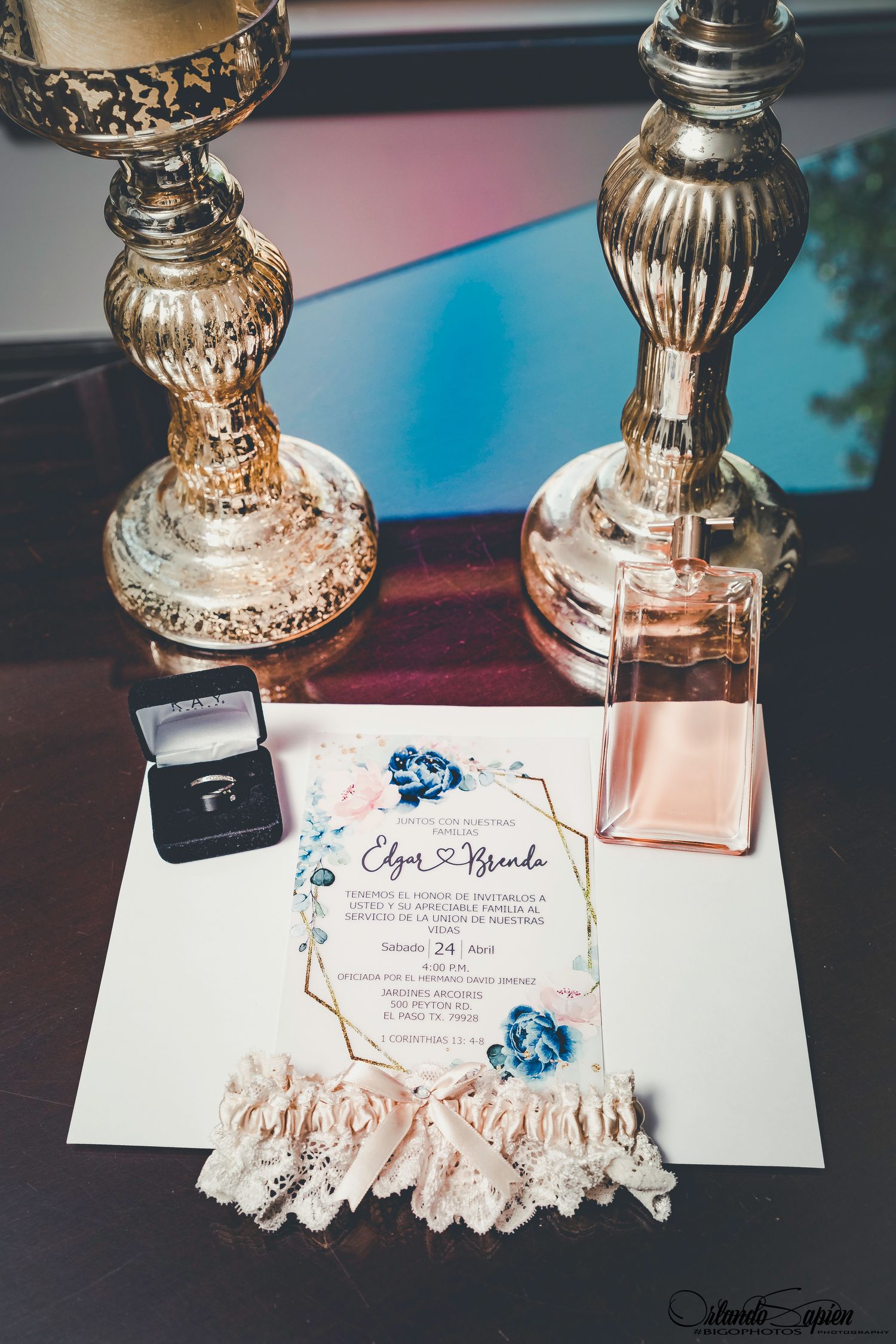 Wedding invitation suite with ornate silver candlesticks and delicate lace details.