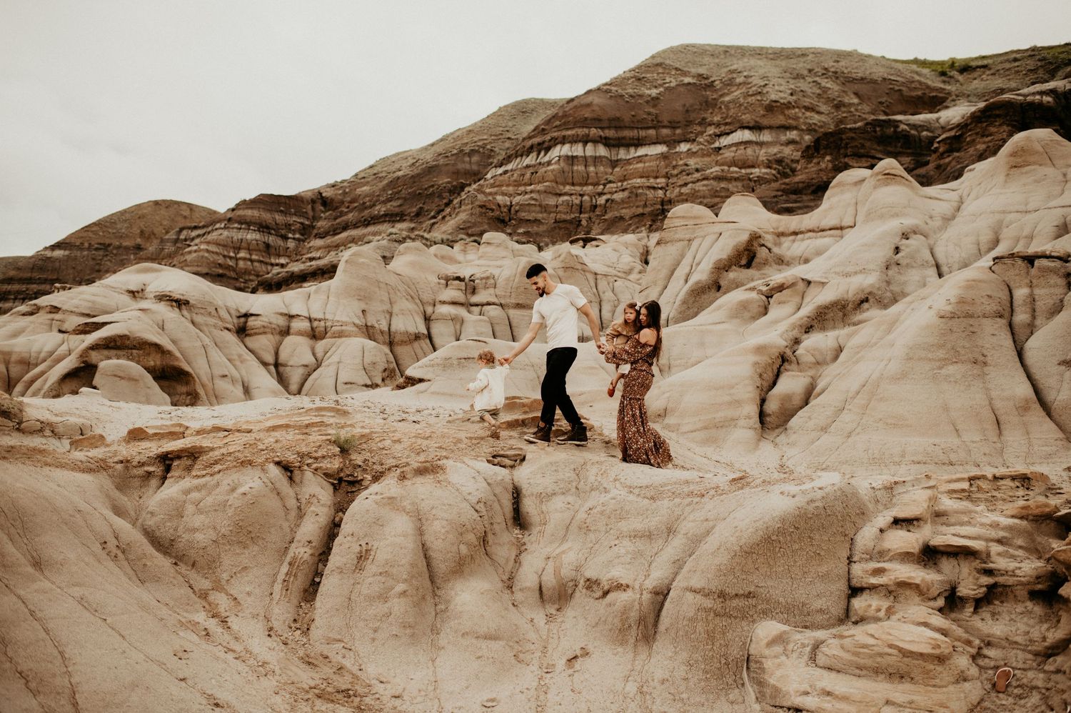 family walking on hoodoos family photography. the photographer behind the lens