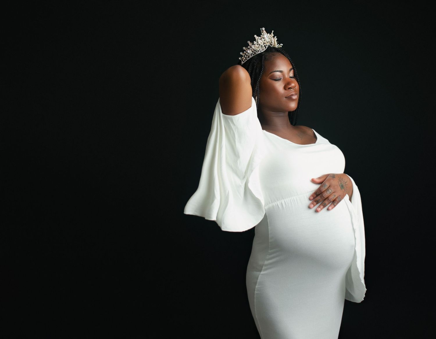 An African American, Black, and proud woman holding her sweet belly for her maternity session. - Upstate  South Carolina Newborn Photography