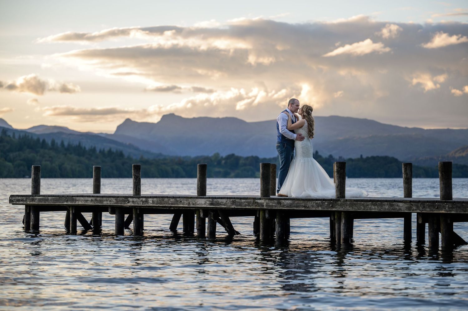 Newlyweds on jetty near Briery Wood Country House in Lake District