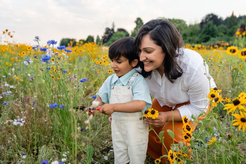 Mother helping her son cut wildflowers in Woodinville.