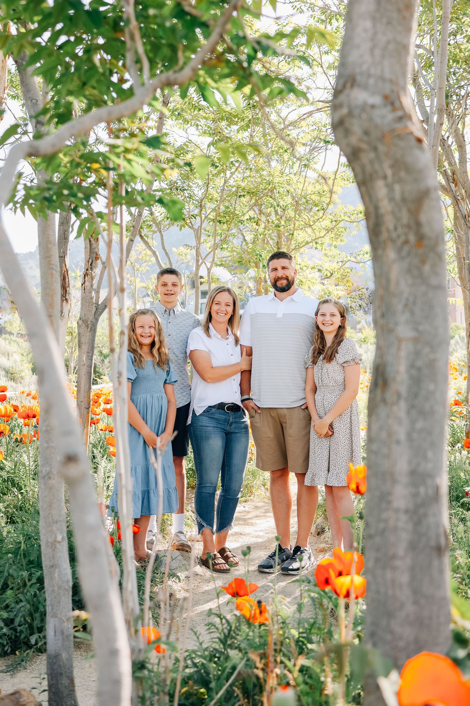 Utah Family Photographer, Family of 5 smiling at camera in the Alpine Poppy Field