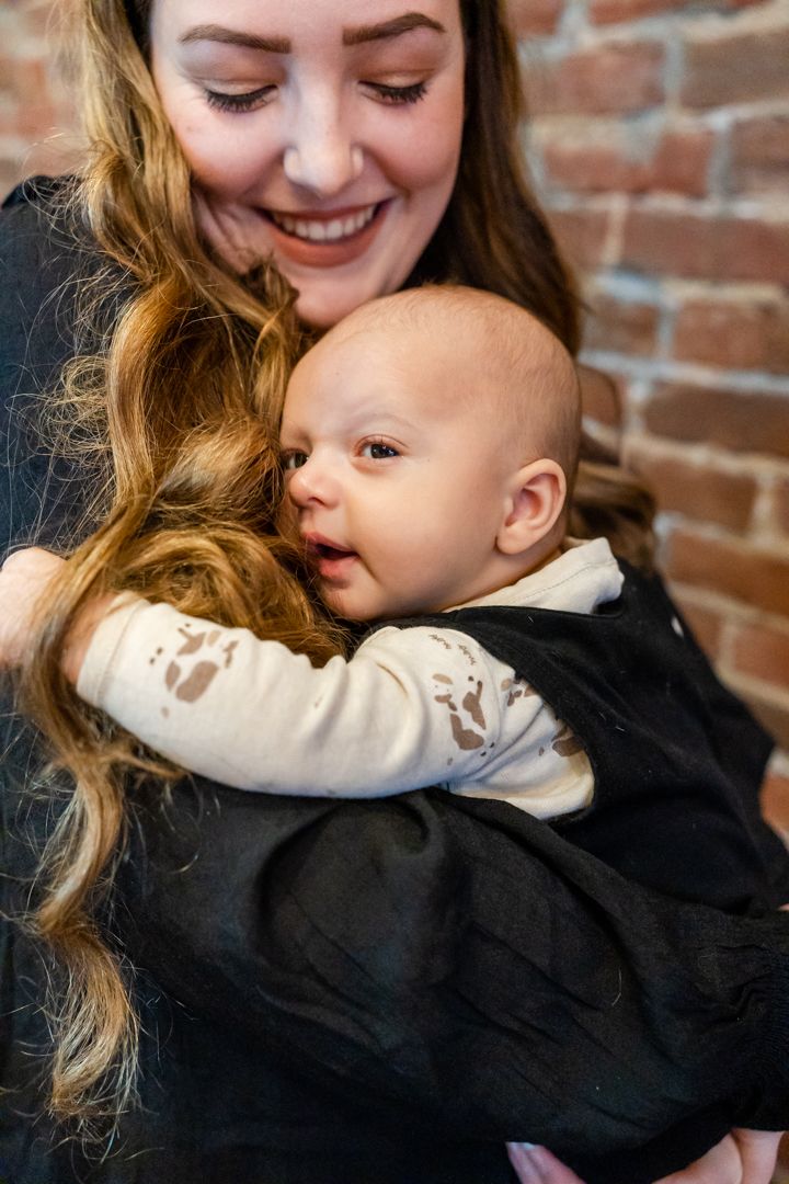 baby boy snuggled into mom