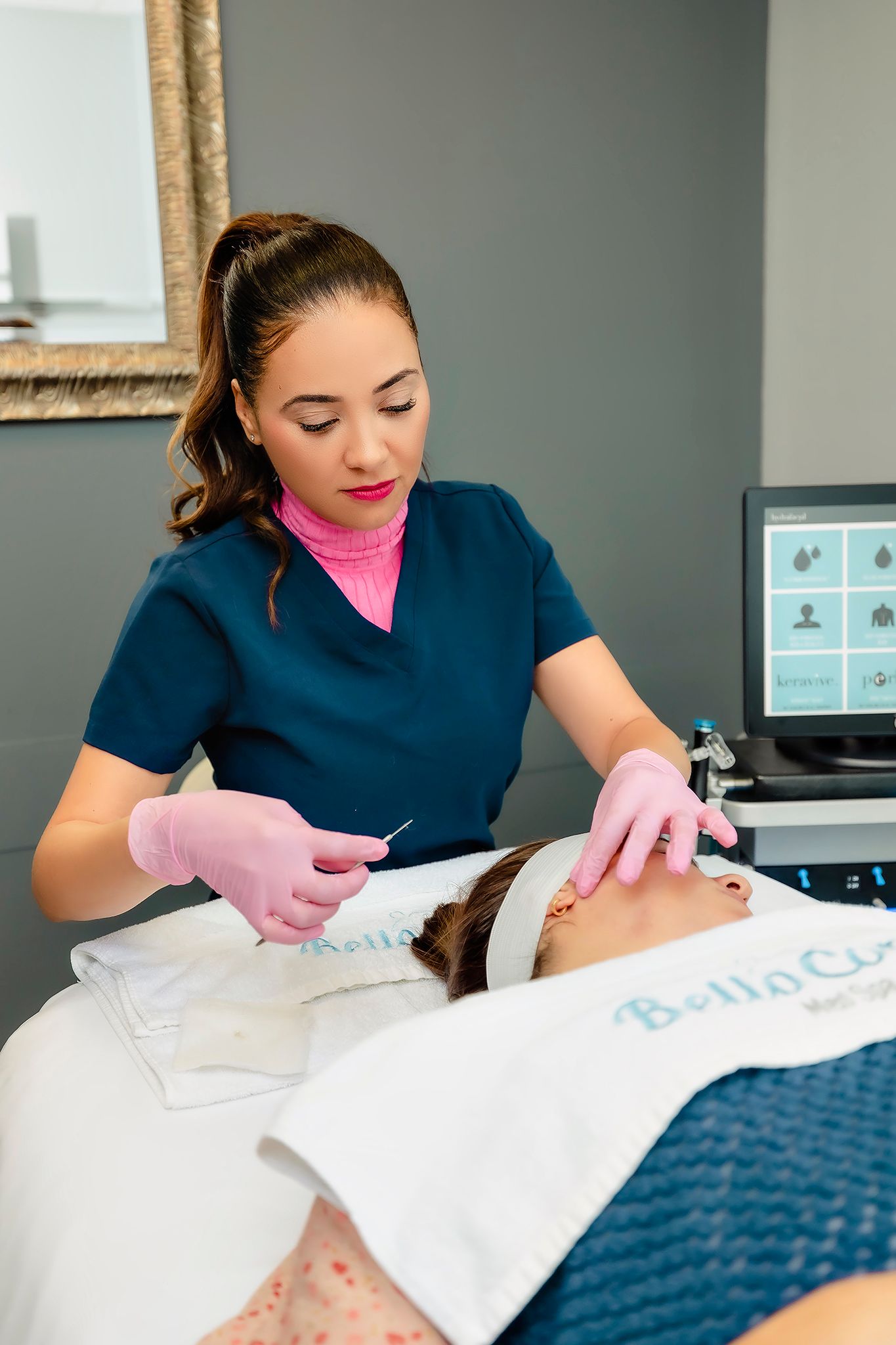 Healthcare provider performing facial treatment on client in medical spa setting.