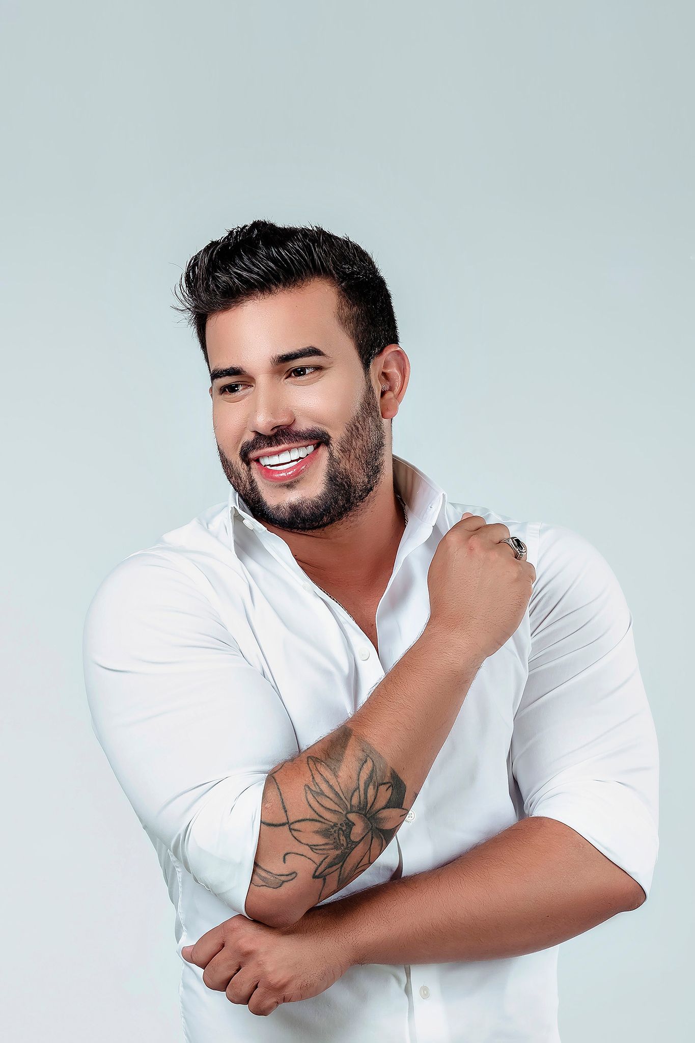 Person in white collared shirt displays tattoo while striking various poses.