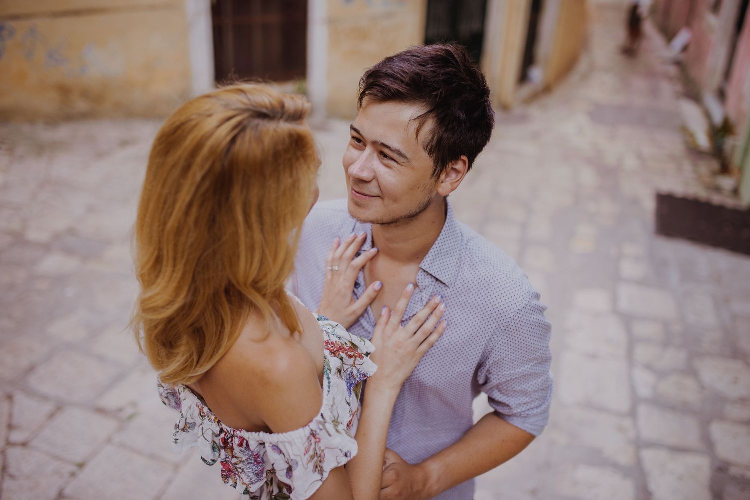 Couple sharing an intimate embrace outdoors with soft lighting and romantic atmosphere.