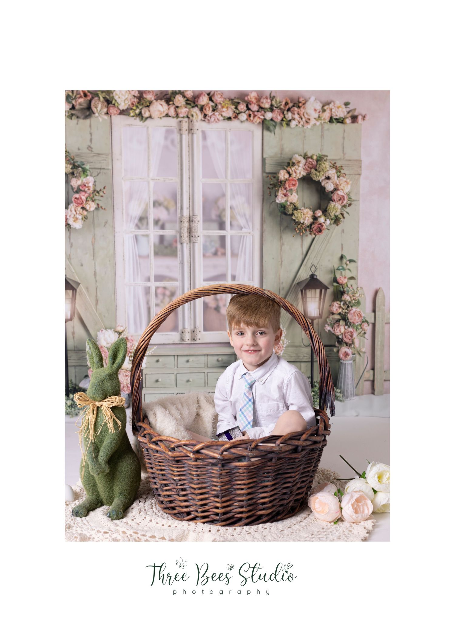 Easter portrait setup featuring wicker basket, vintage window backdrop and green plush bunny.