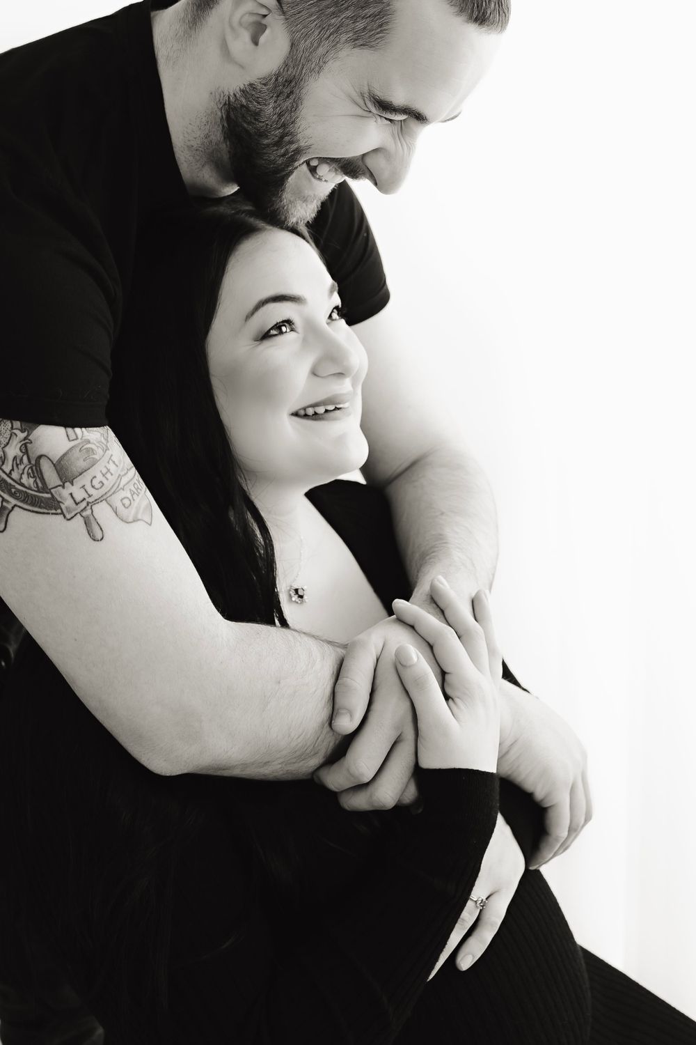 Black and white intimate couple portraits showing tender moments against white background.