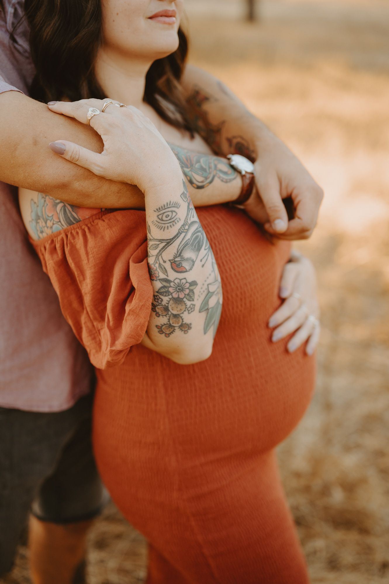 grassy field maternity photos by Thousand Oaks maternity photographer, of with hand on belly embraced by husband