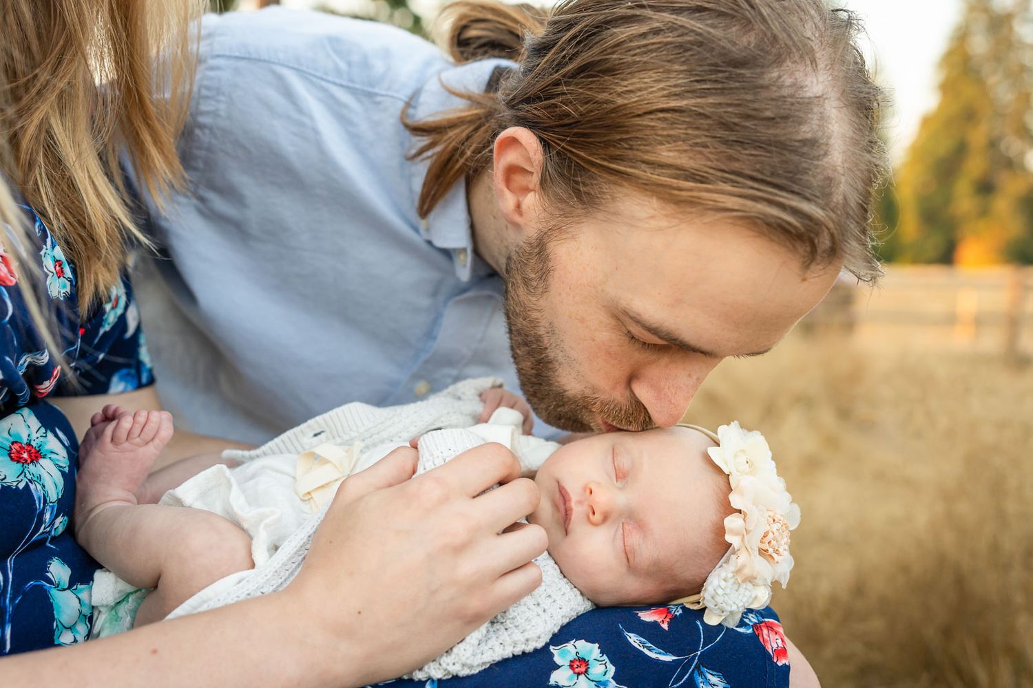 Father kisses newborn daughter