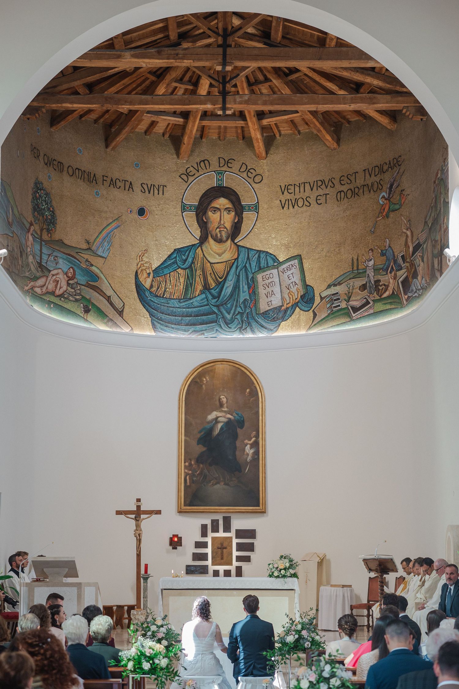 Church interior with beautiful Byzantine-style mosaic of Christ on the dome ceiling.