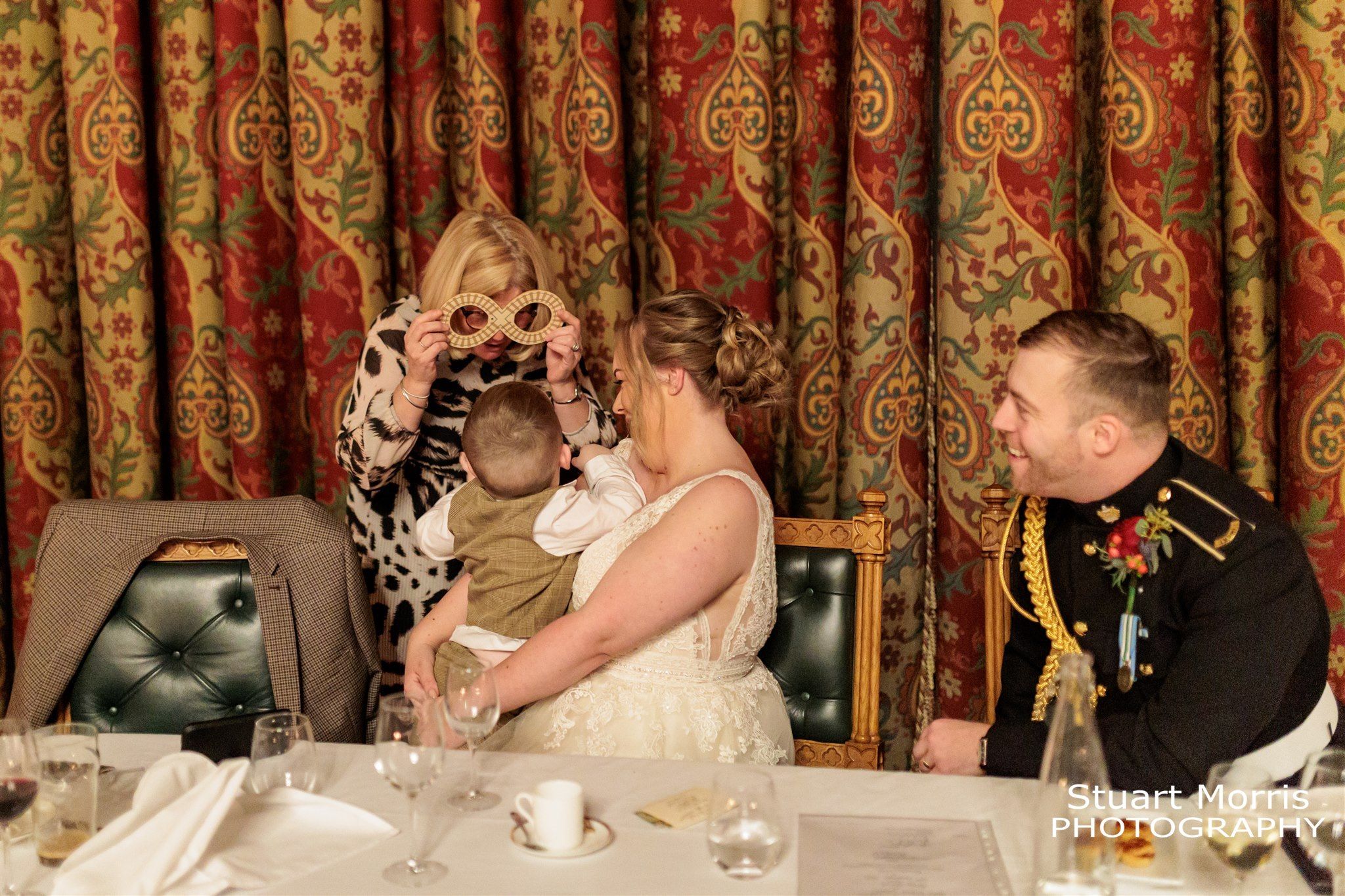 Wedding guest plays with the newlyweds young son after the wedding breakfast. Knowsley hall wedding photographer