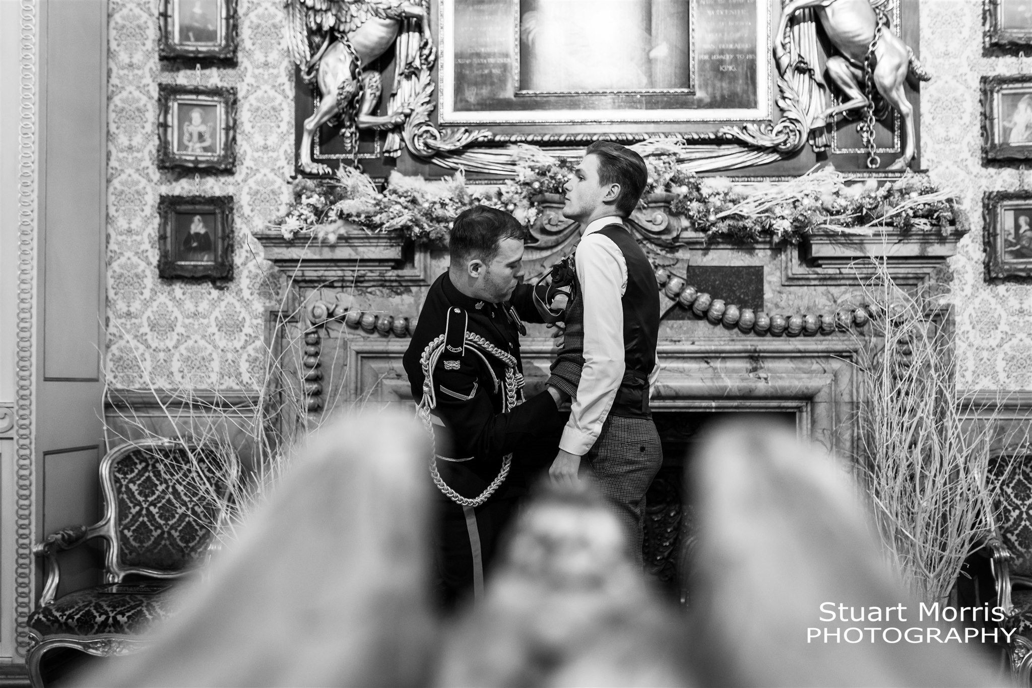 Groom helps straighten the brides man of honours tie. Knowsley hall wedding photography