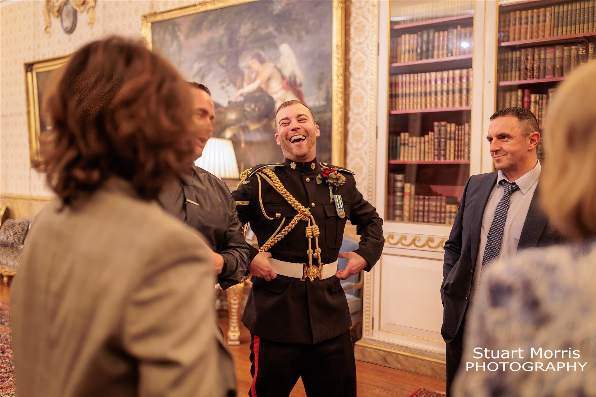 Groom enjoying a laugh with wedding guests. Knowsley Hall wedding photographer. Liverpool Wedding photography.