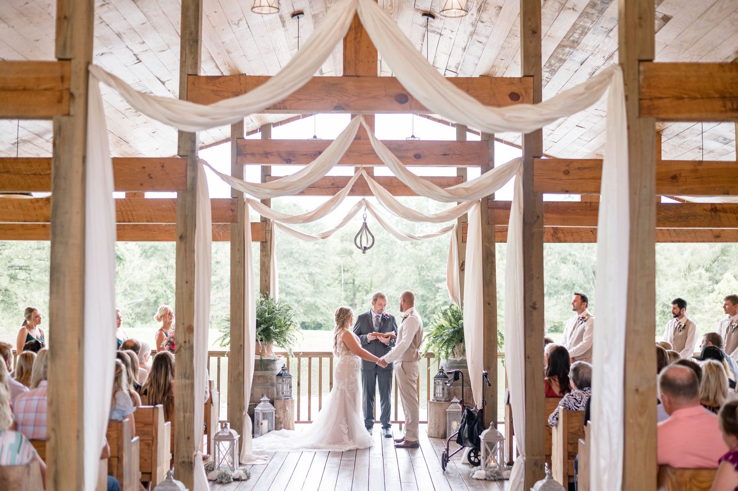 bride and groom exchange vows cedar post barn