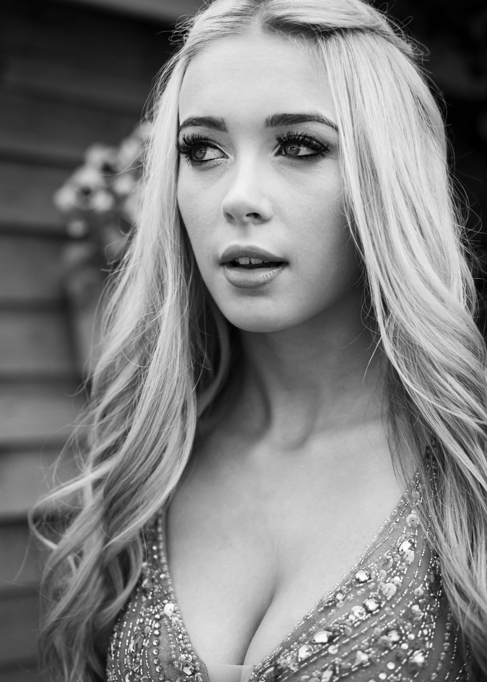 Monochrome portrait featuring elegant hairstyling and formal attire.